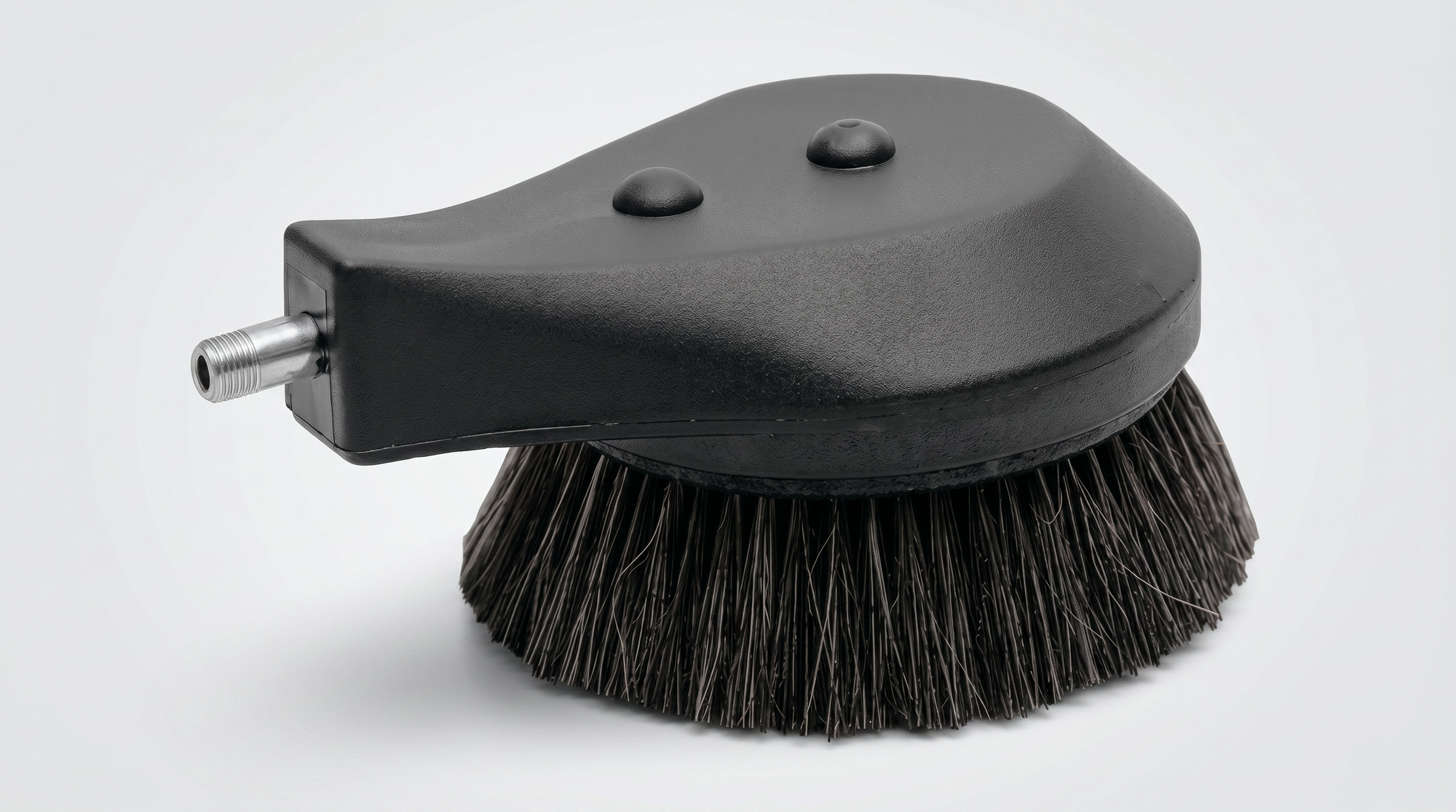 Round black pressure-washer brush attachment with dense bristles and threaded inlet connection.