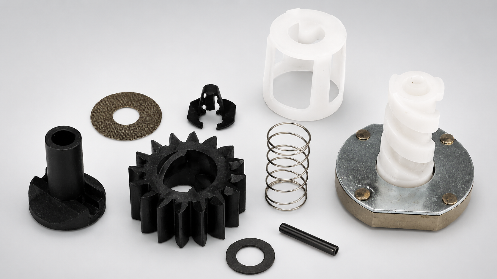 Assortment of pressure-washer engine parts, including impeller, spring, washers, clips, housing, and mounting components.