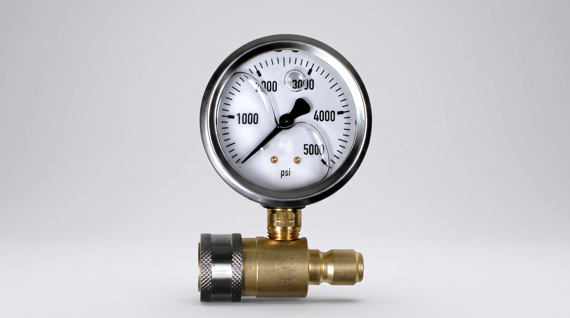 High-pressure gauge rated to 5,000 PSI with brass quick-connect fitting and protective stainless steel bezel.