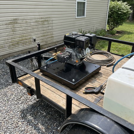 Skid Base Plate carrying a gas engine on the bed of a utility trailer.
