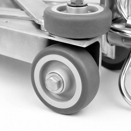 Close-up of the front wheel with mounted on the duct cleaning trolley.