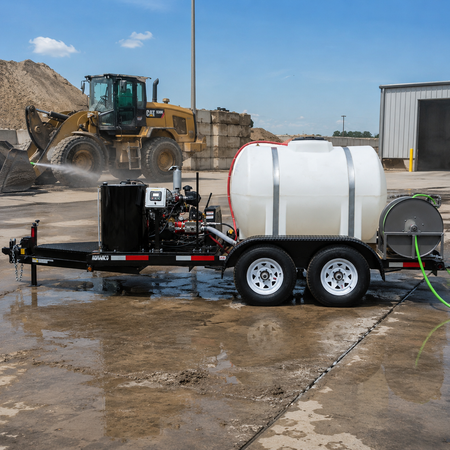 15,000 PSI diesel cold water trailer pressure washer in an outdoor construction setting with a CAT wheel loader in the background.
