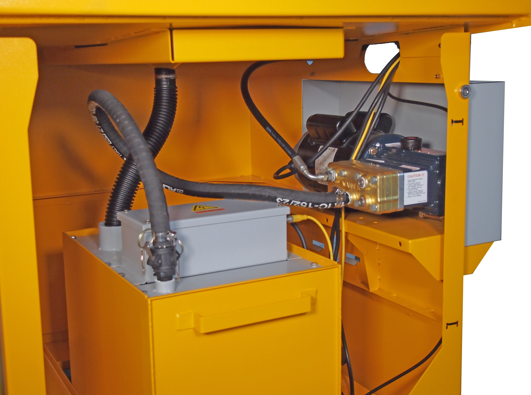 Interior view of the Tempest-20S parts washer cabinet, showing the mechanical and electrical components, including a grey box and orange wiring, within a yellow metal framework.
